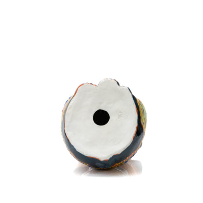 White underside of the lucky cat with a round opening.