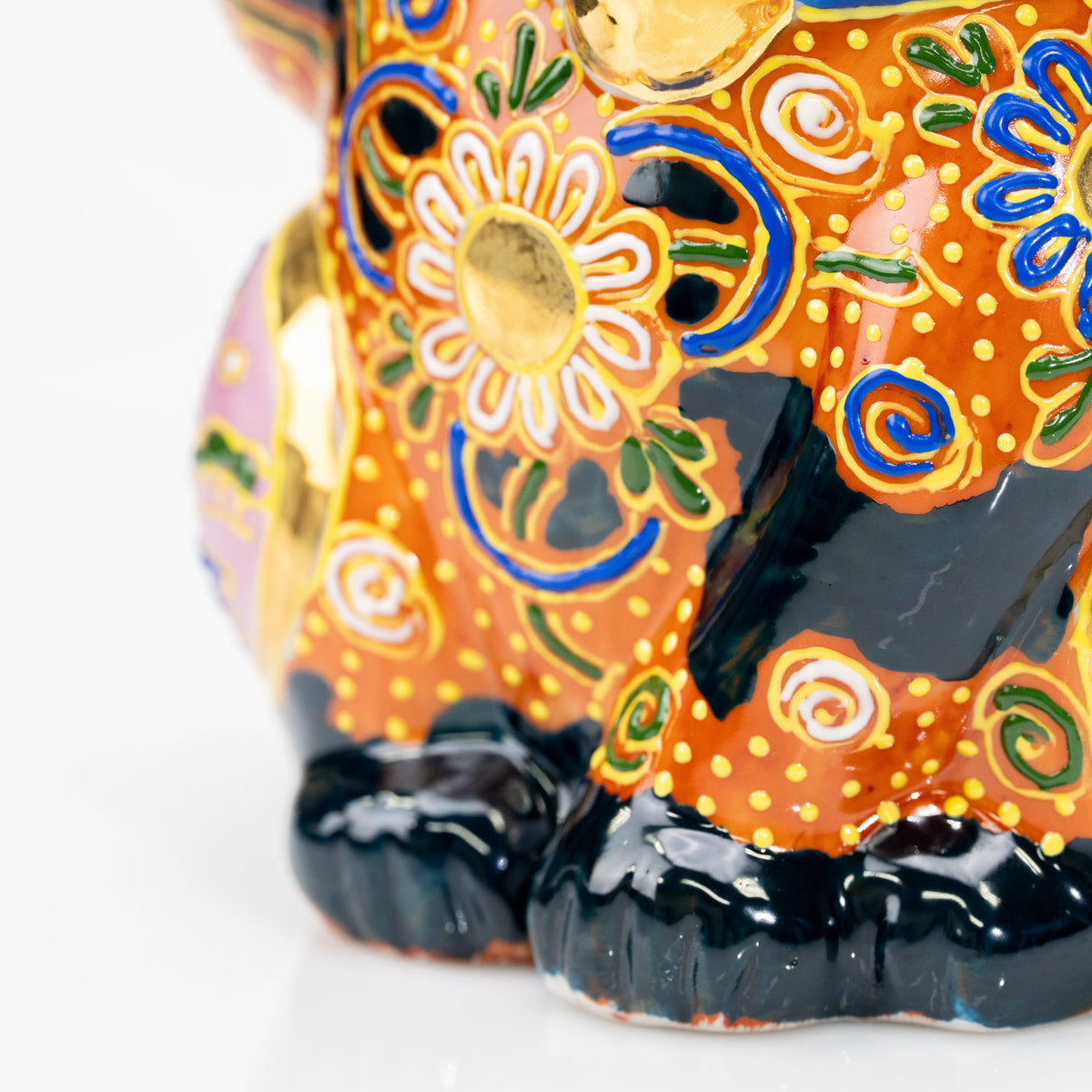 Gold-outlined flowers above the cat's black feet.