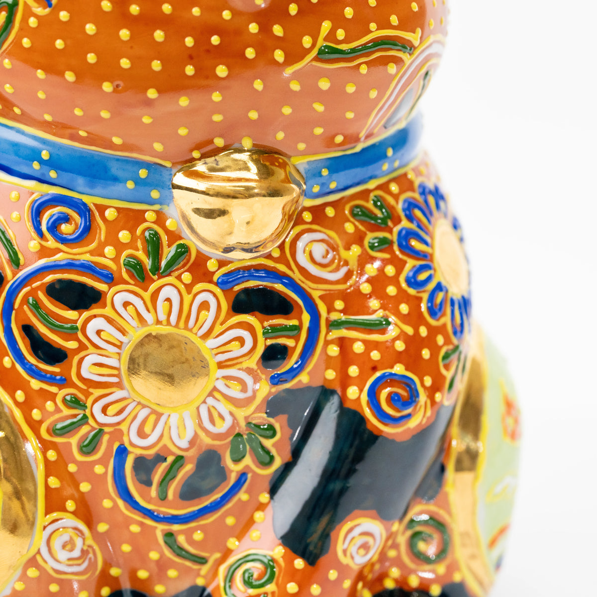 Gold bell below the cat's blue collar.