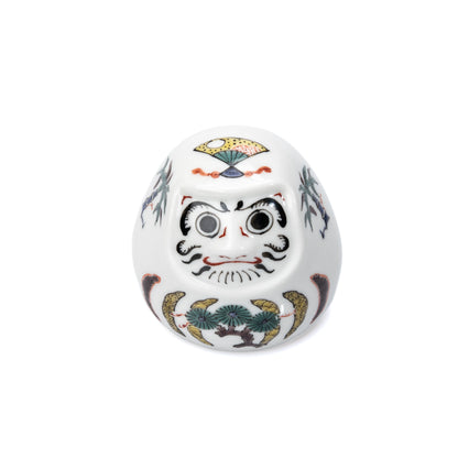White Kutani daruma with painted pine, bamboo and plum decoration on white.