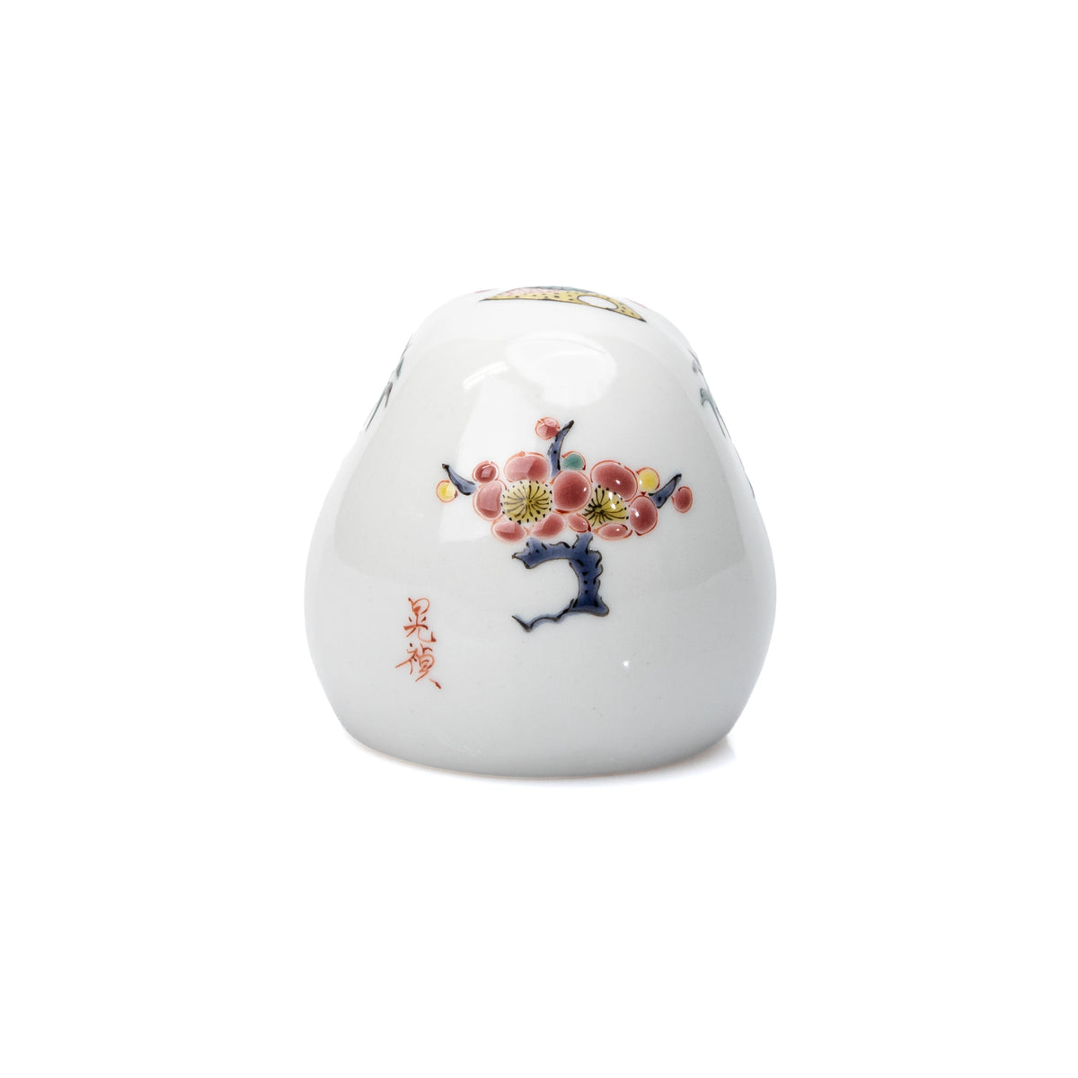 Flowering plum and red inscription painted on the daruma's back.