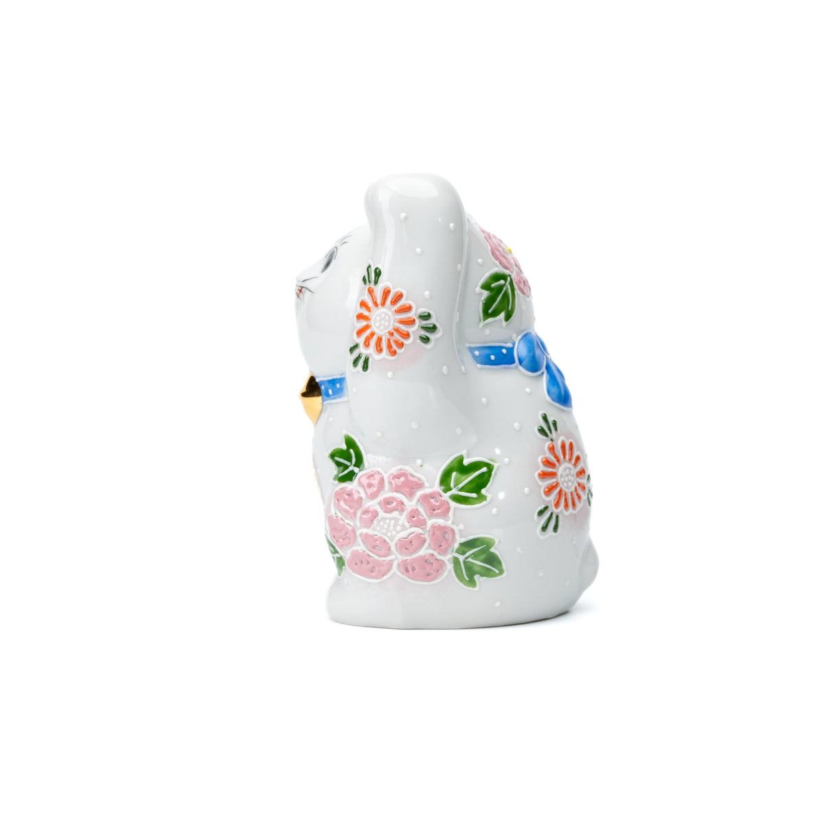 Side view of the white lucky cat with pink and blue flowers.