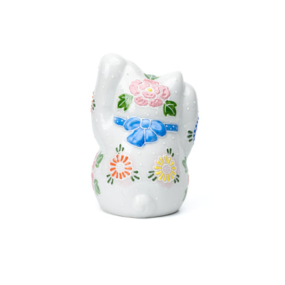 Back of the white lucky cat with colorful floral decoration.