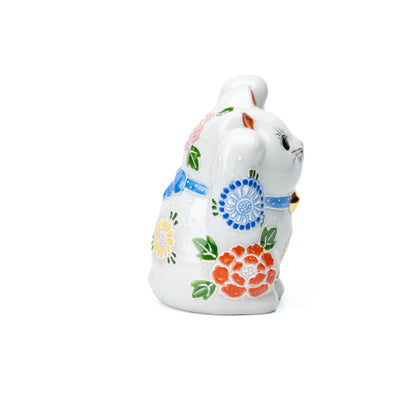 Opposite side of the white lucky cat and its raised paws.