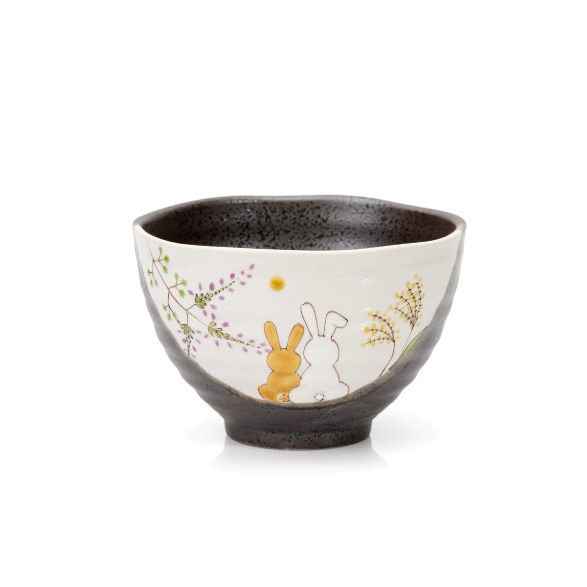 Dark glazed Kutani bowl with two seated rabbits and painted grasses on a cream panel.