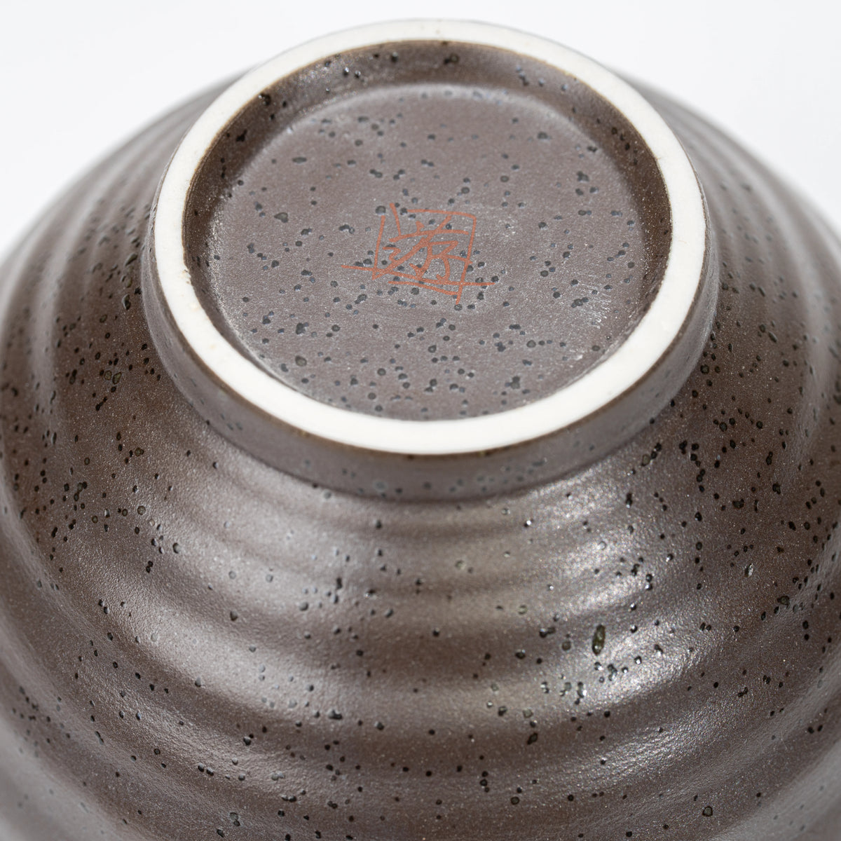 Circular foot and recessed underside of the rabbit bowl.