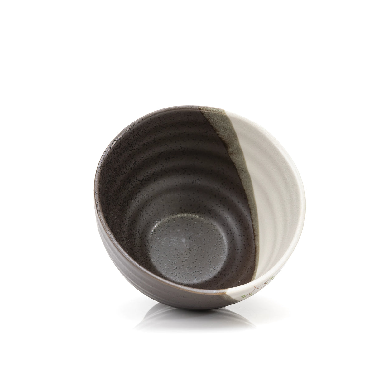 Overhead view into the dark glazed rabbit bowl.