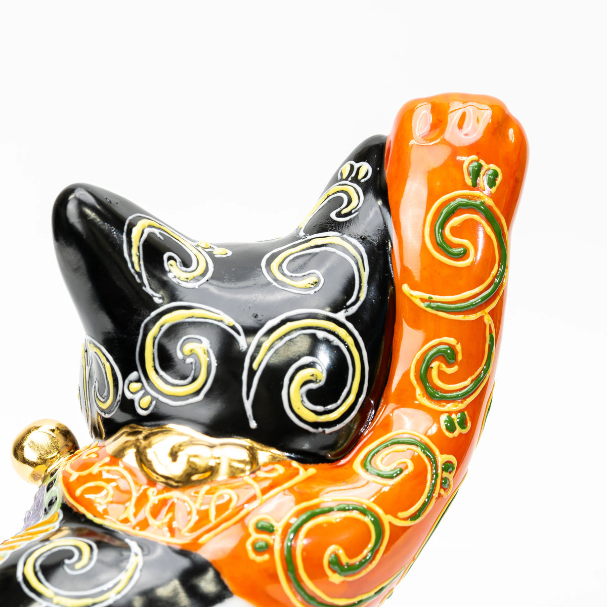 Close-up of gold scrolls and the orange raised paw.