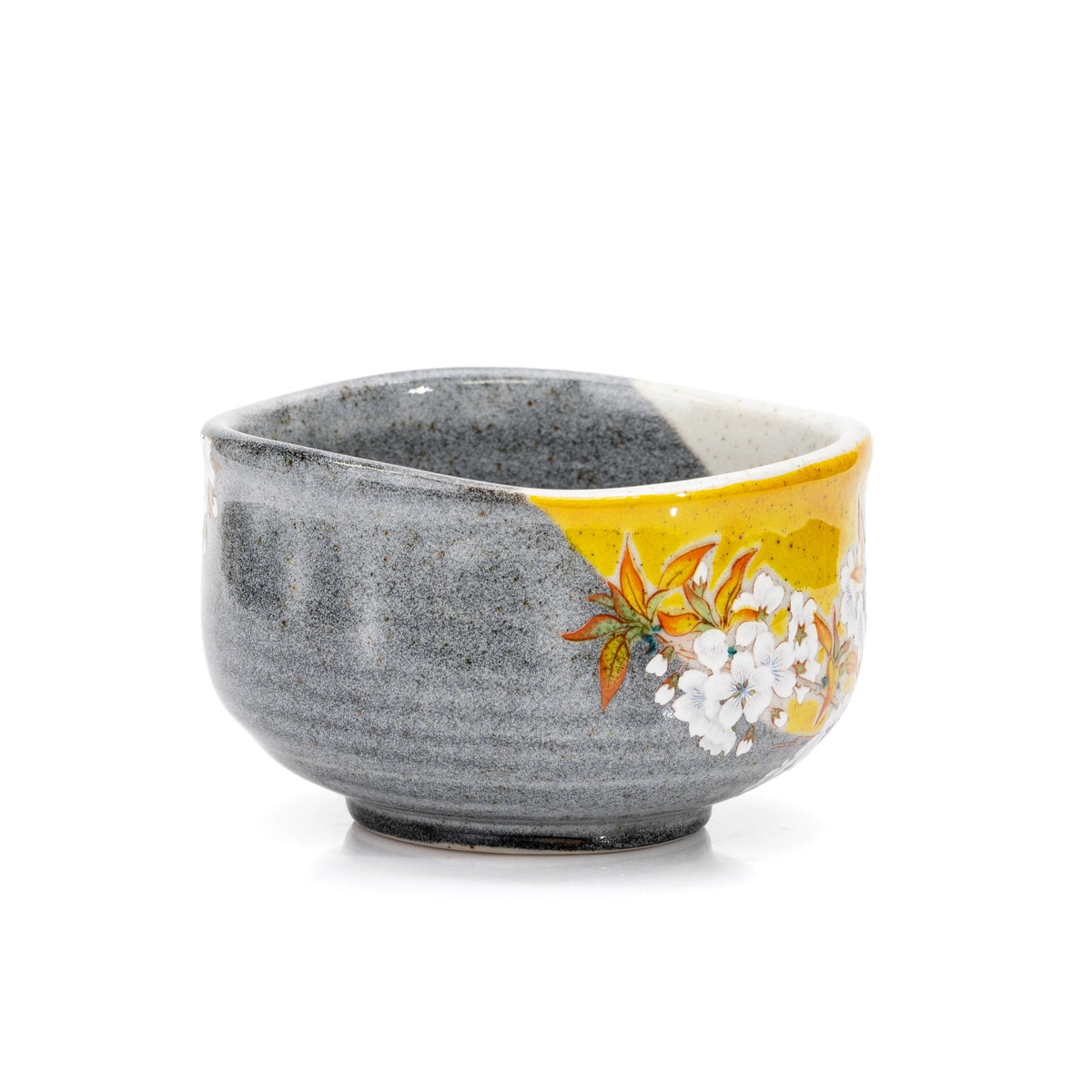 Side view of the matcha bowl's yellow floral panel and gray glaze.