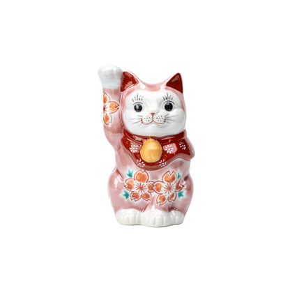 Pink cherry blossom lucky cat with one raised paw, red bib and gold bell on white.
