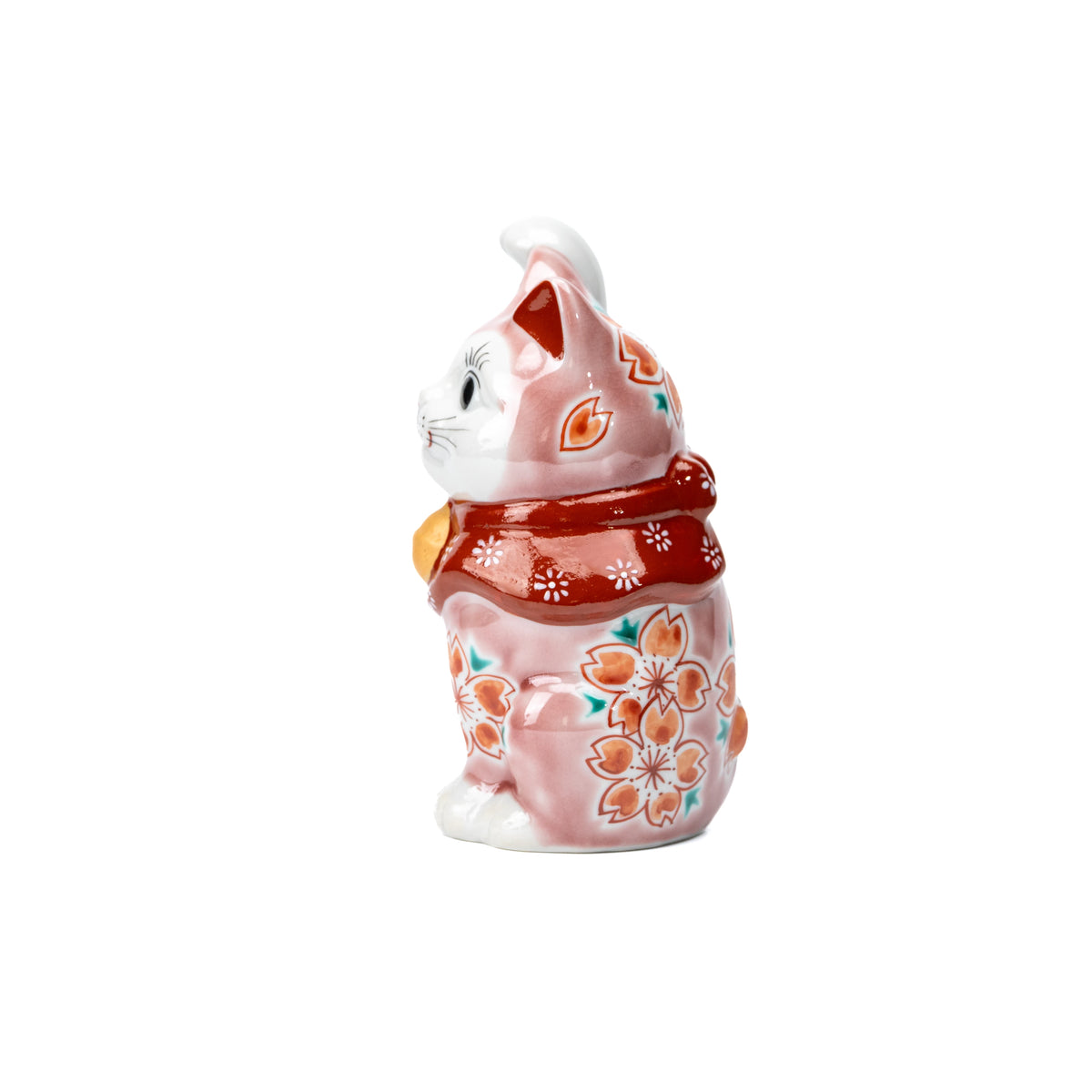 Side view of the pink lucky cat and its raised paw.