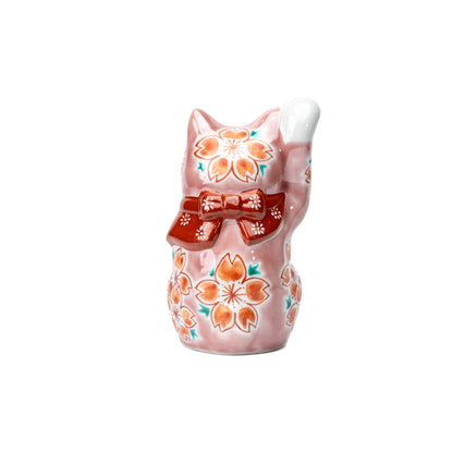 Back of the pink lucky cat with cherry blossoms and a red bow.