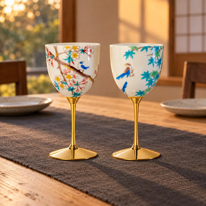 Pair of Kutani porcelain wine cups with spring blossoms and autumn maple birds on a quiet dining table