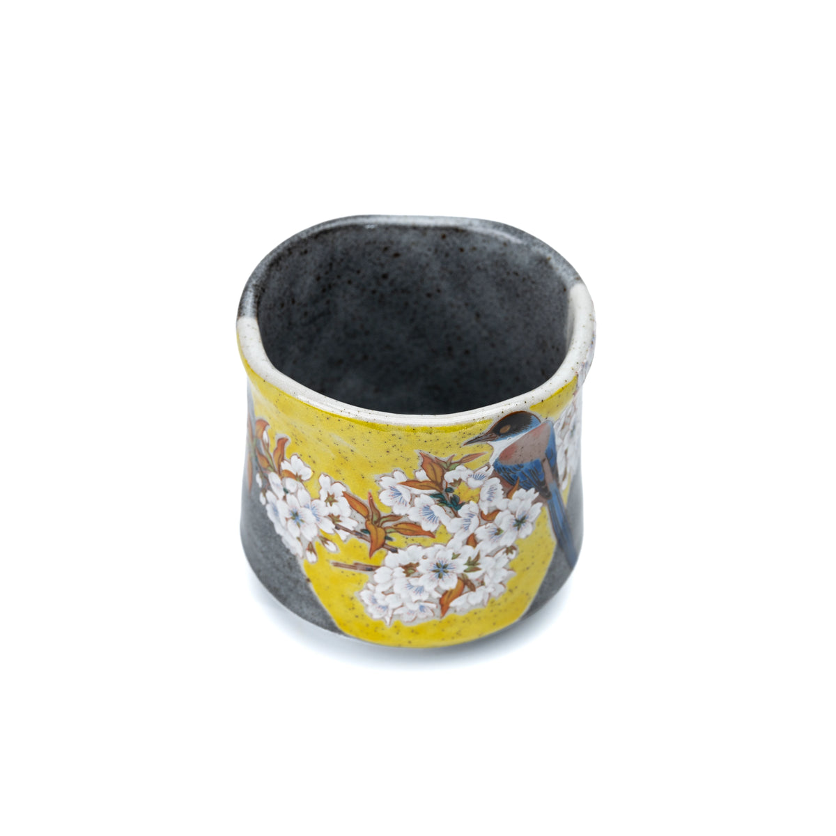 Angled view of the Kutani yunomi showing its dark glazed interior.