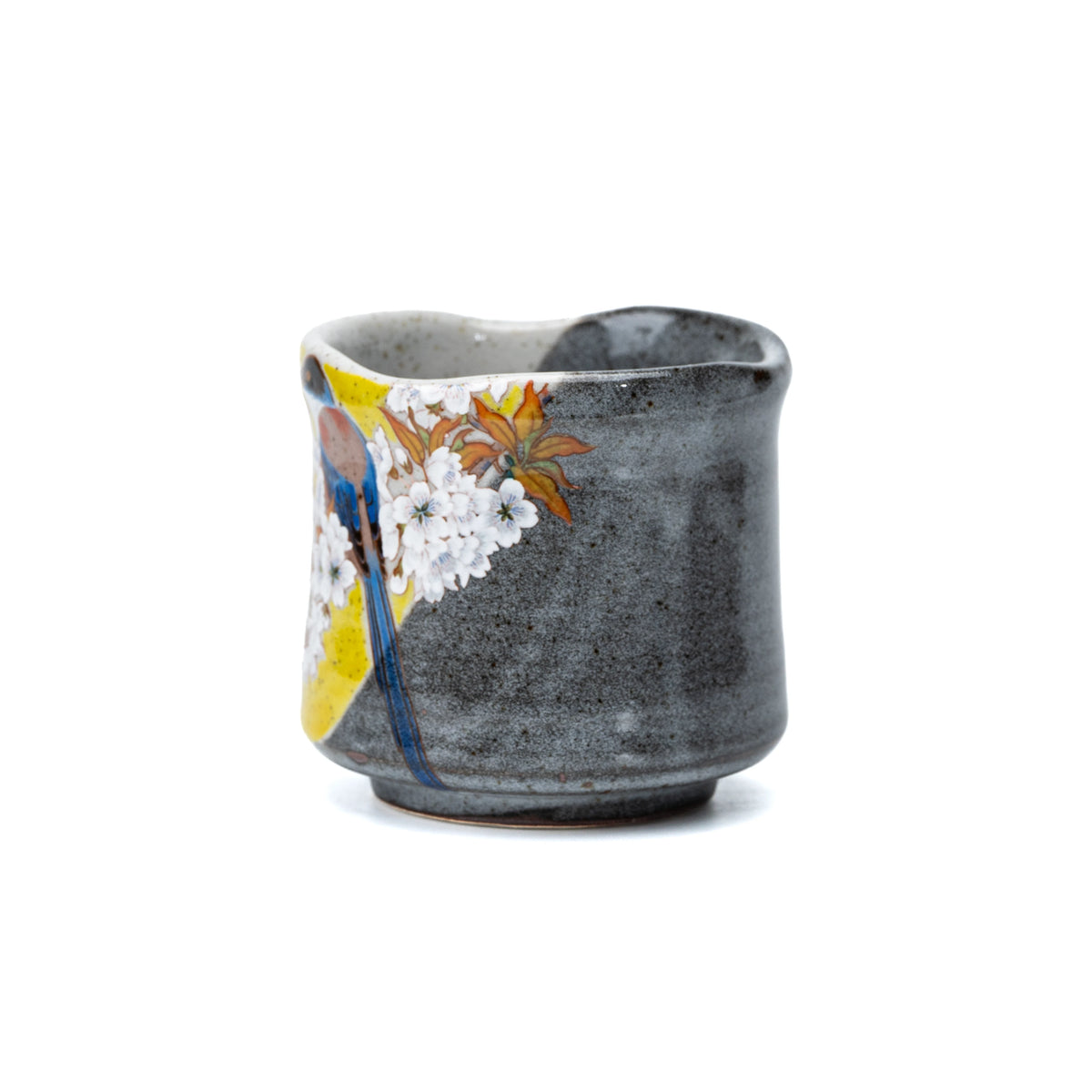 Side view of the yellow bird decoration and textured gray glaze on the yunomi.