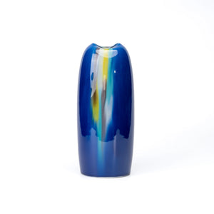 Tall blue Kutani porcelain vase with flowing green, yellow and pale blue glaze on white.