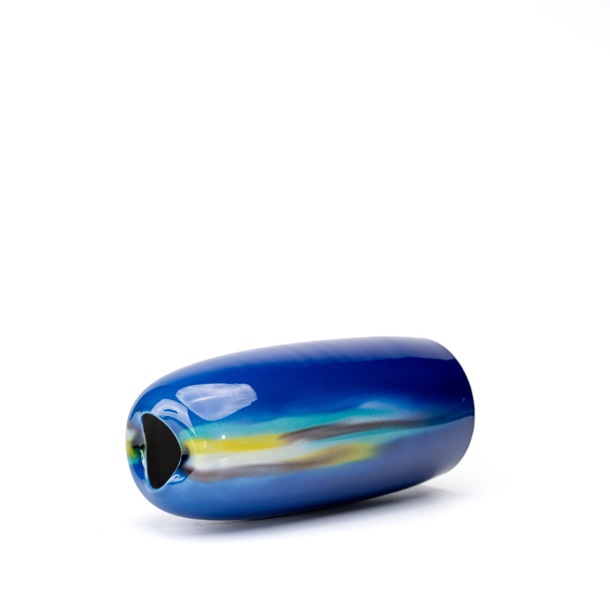 Blue vase lying on its side, showing the opening and flowing colored glaze.