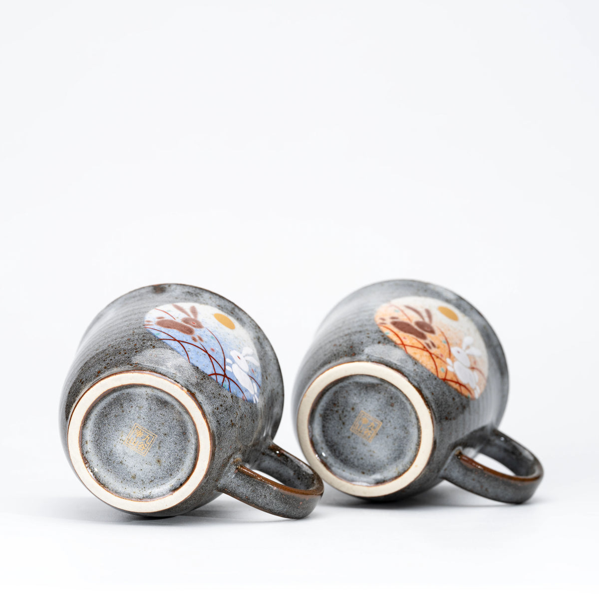Circular feet and glazed undersides of the rabbit mug pair.