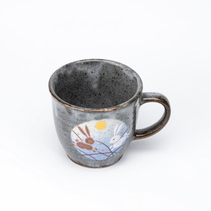 Blue-panel rabbit mug viewed from above.