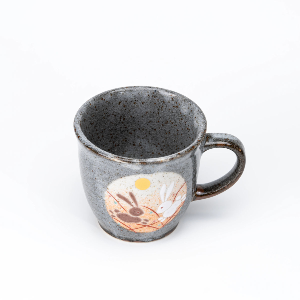 Orange-panel rabbit mug viewed from above.