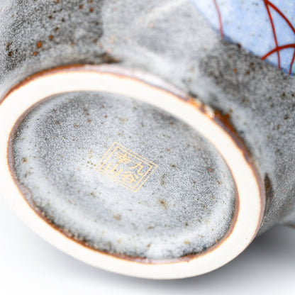 Gold-colored maker's mark on the underside of a rabbit mug.