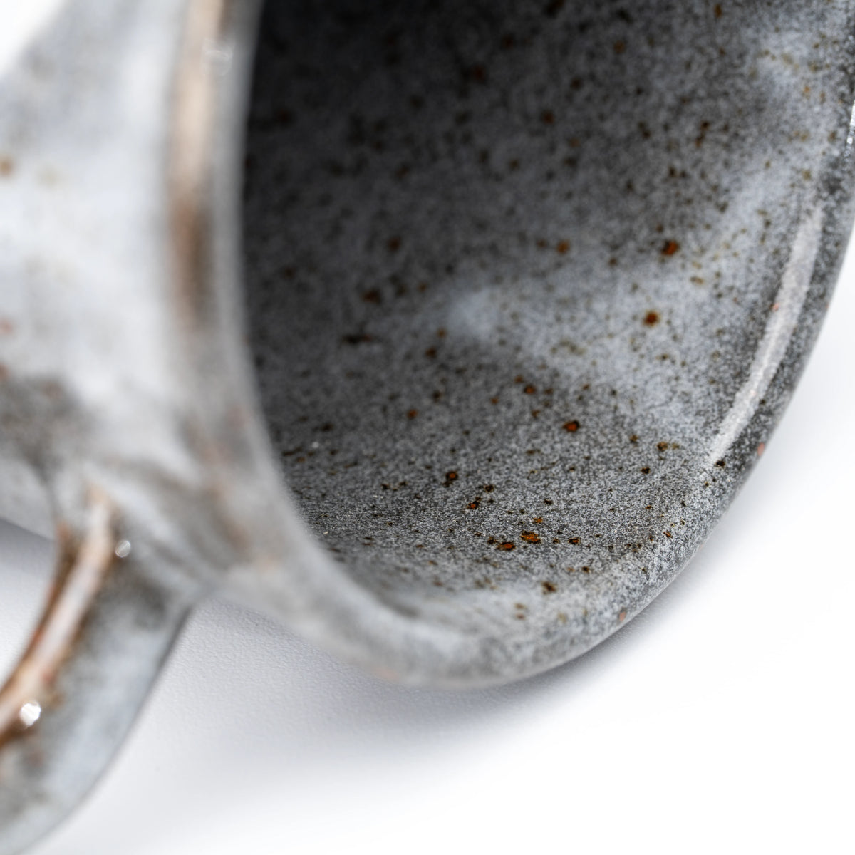 Close-up of the gray speckled interior and rounded rim.