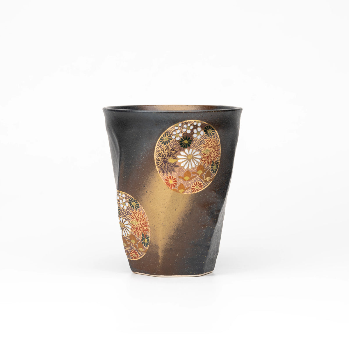 Black Kutani cup with round floral medallions and gold-colored decoration on a white background.
