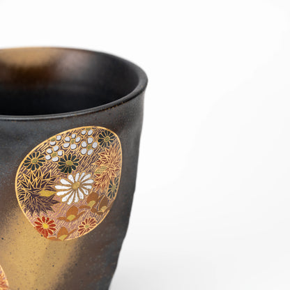 Close-up of a floral medallion near the Kutani cup's rim.