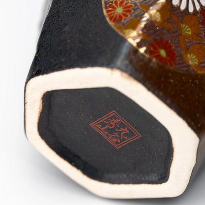 Close-up of the Kutani cup's foot ring and red maker's mark.