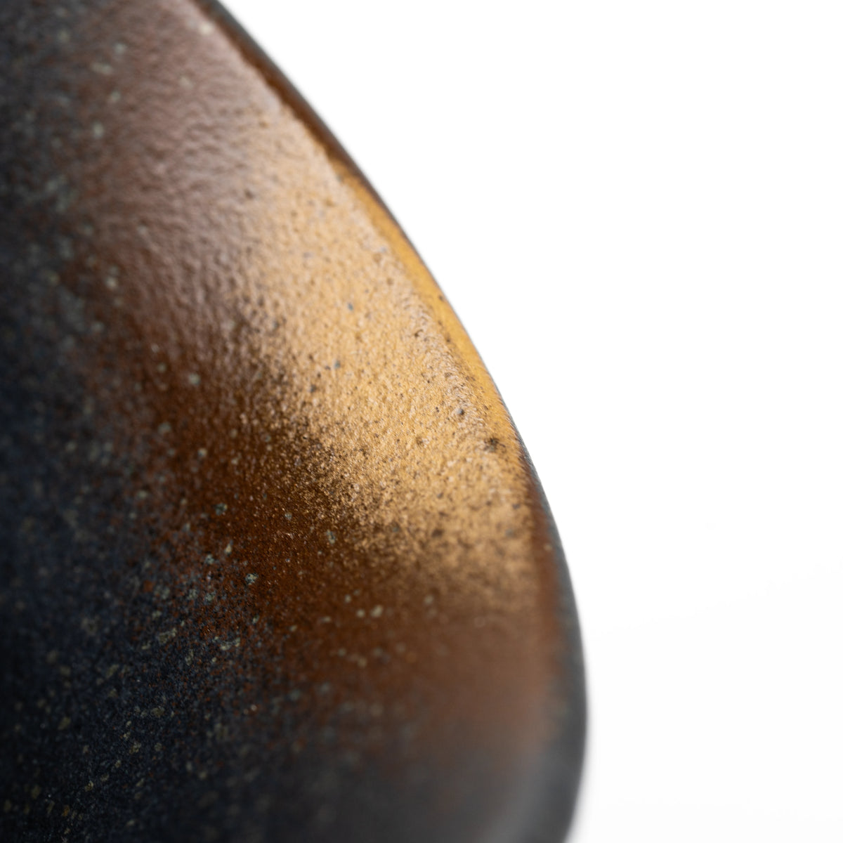 Close-up of the Kutani cup's curved dark surface and gold-colored shading.