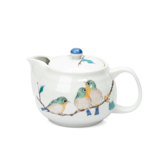 White Kutani teapot with three green birds on a branch and a blue lid knob.