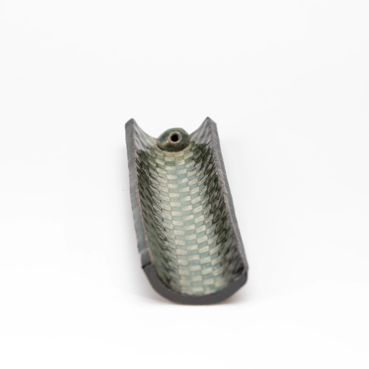 Top view of the green mosaic incense holder without an incense stick.