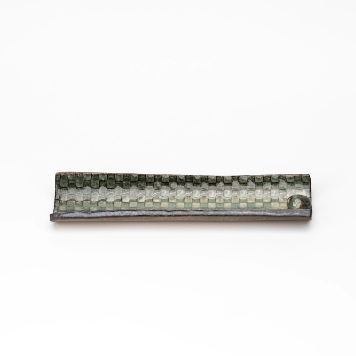 Long green mosaic incense tray shown from above.