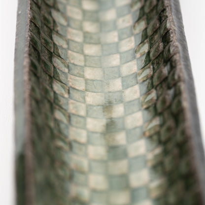 Close-up of green and cream squares inside the incense tray.