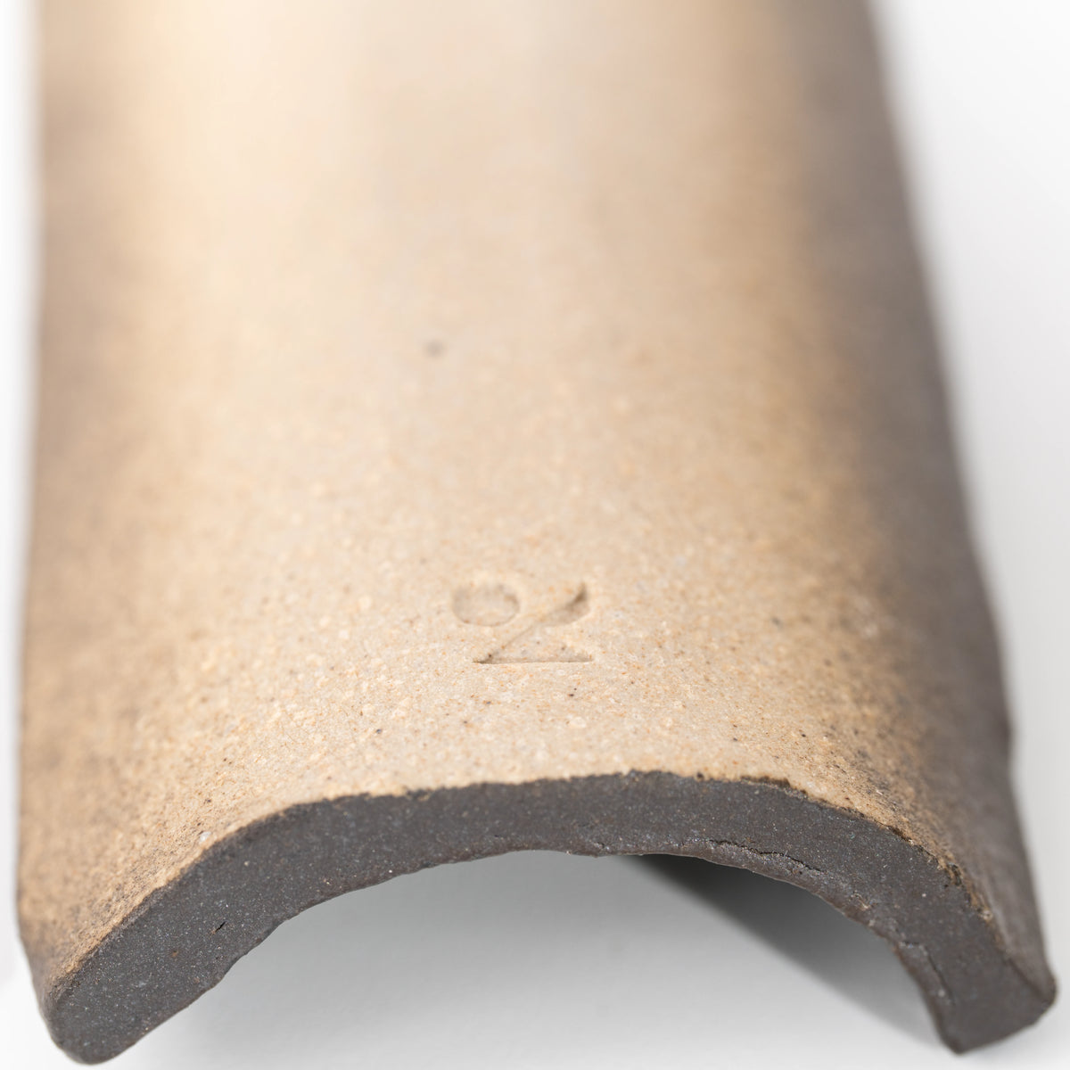 Close-up of the stamped mark underneath the mosaic incense holder.