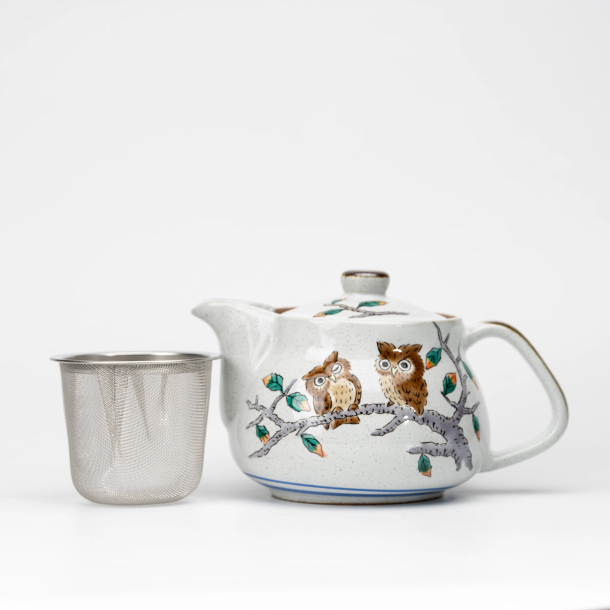Kutani owl teapot with its removable mesh strainer beside it.