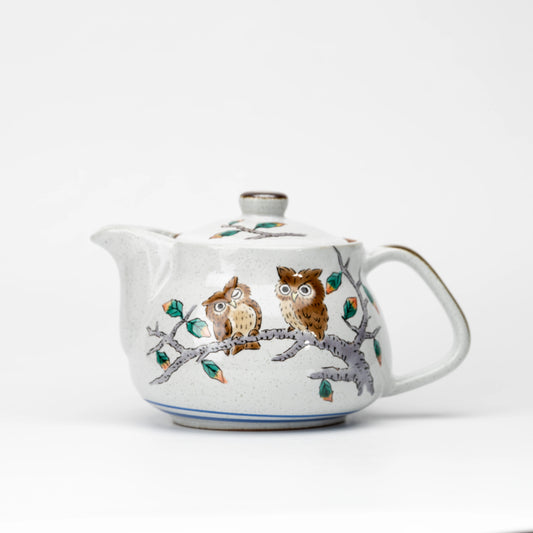 Front view of a Kutani owl teapot with painted owls on a branch and a fitted lid.
