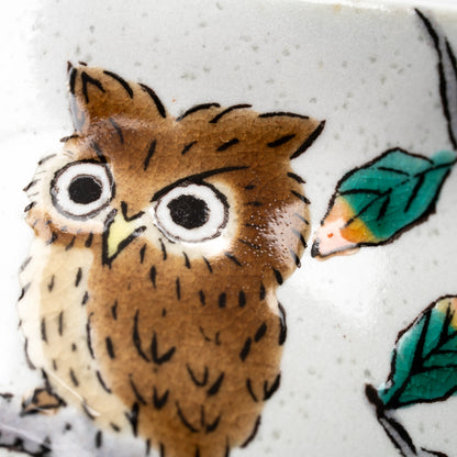 Close-up of the small owl and green leaves on the Kutani teapot.