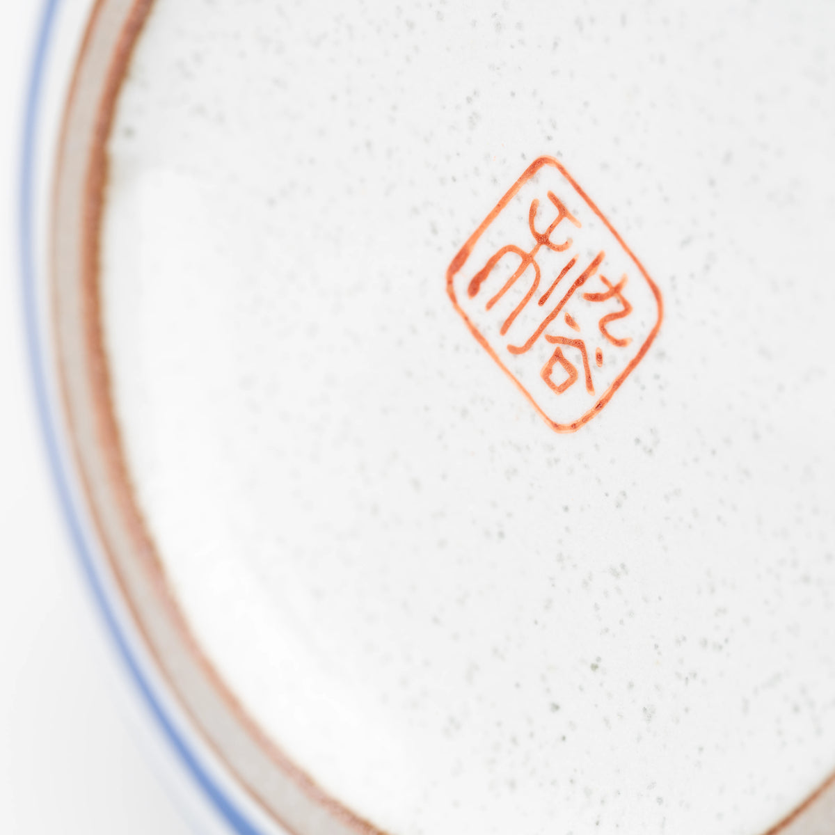 Close-up of the red maker's mark underneath the Kutani owl teapot.