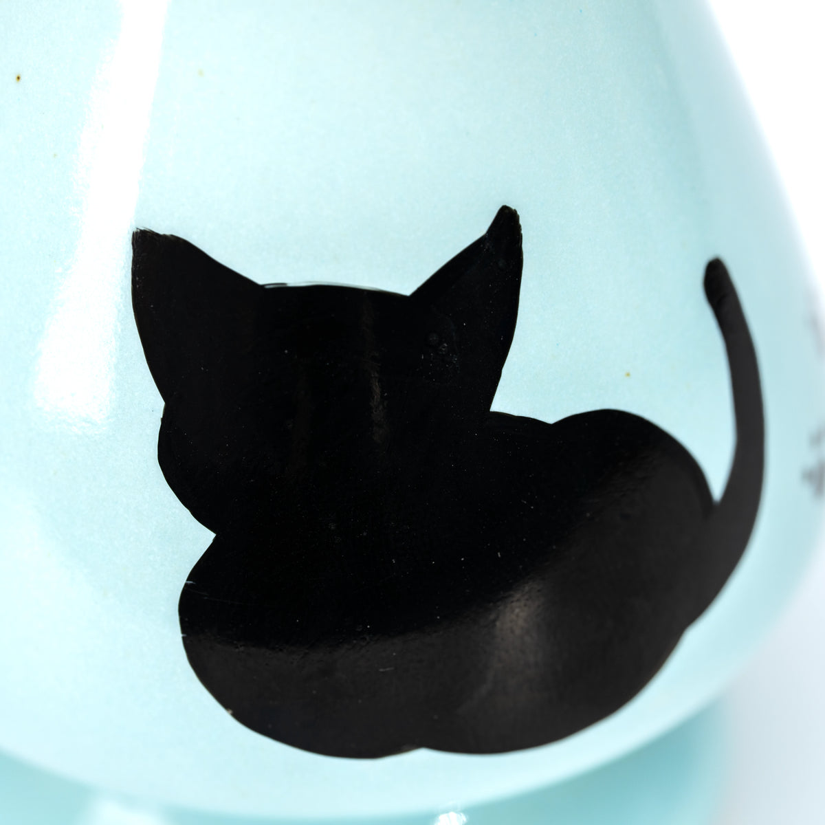 Close-up of the hand-painted black cat silhouette.