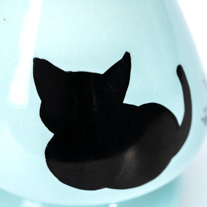 Close-up of the hand-painted black cat silhouette.