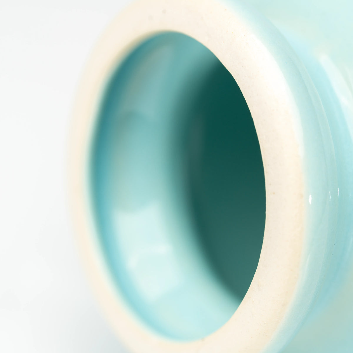 Pale blue glaze around the holder's upper opening.