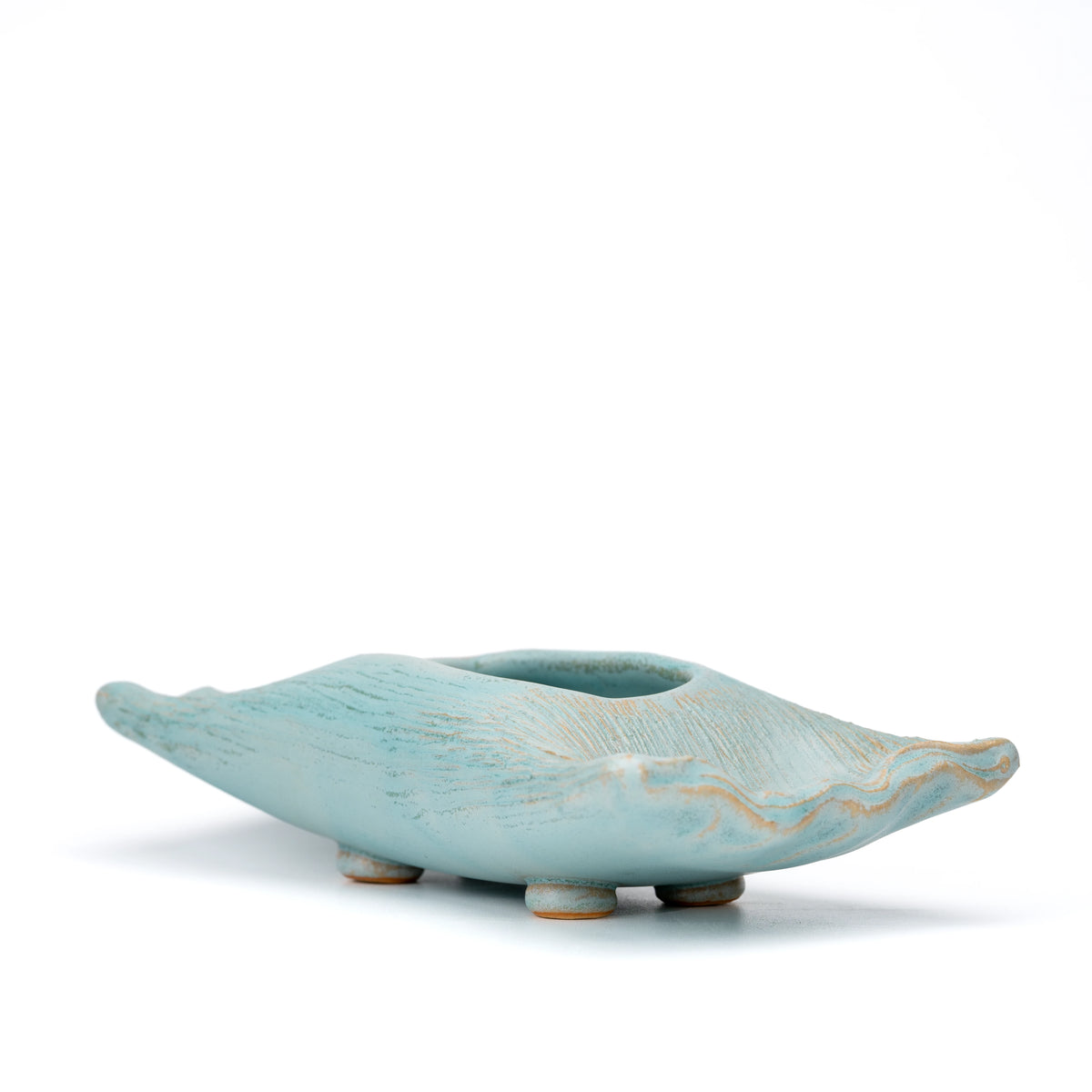 Angled side view of the pale blue Hechimon vase and its rippled rim.