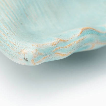 Close-up of the rippled rim and textured pale blue glaze.