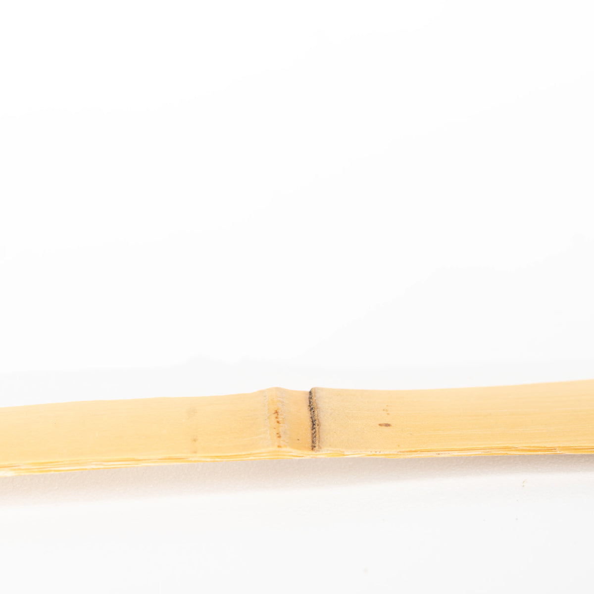 Natural bamboo grain and node along the scoop handle.