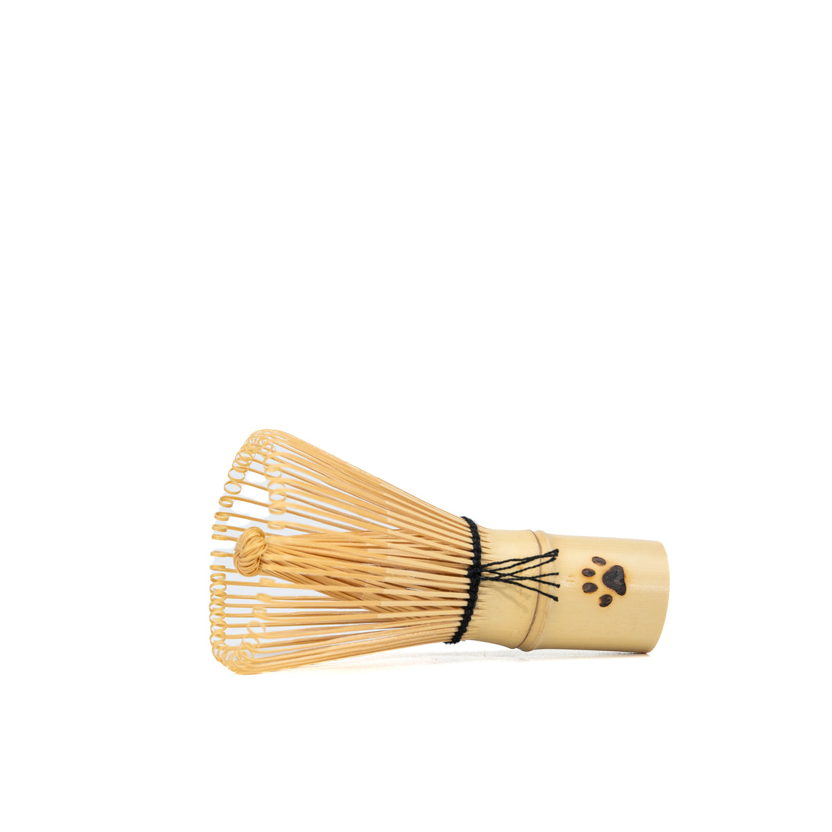 Paw-print bamboo mini whisk lying on its side.