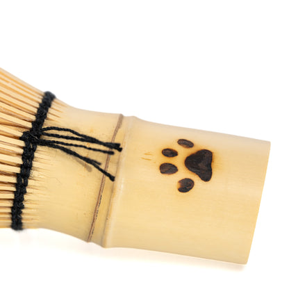 Close-up of the paw print and black thread around the bamboo handle.