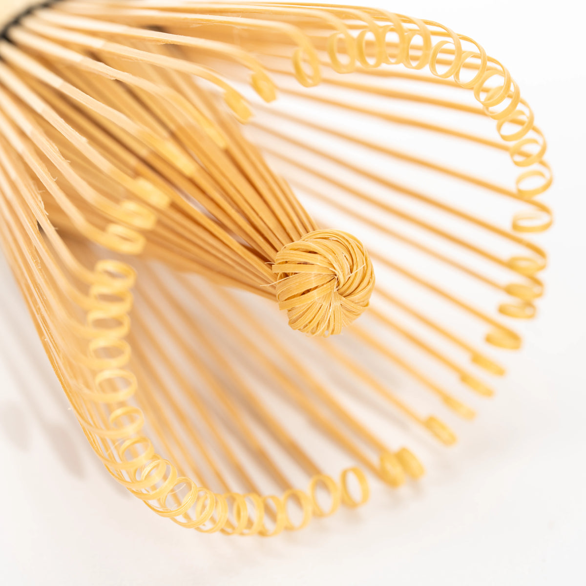 Top view of the whisk's fine curled bamboo tines.