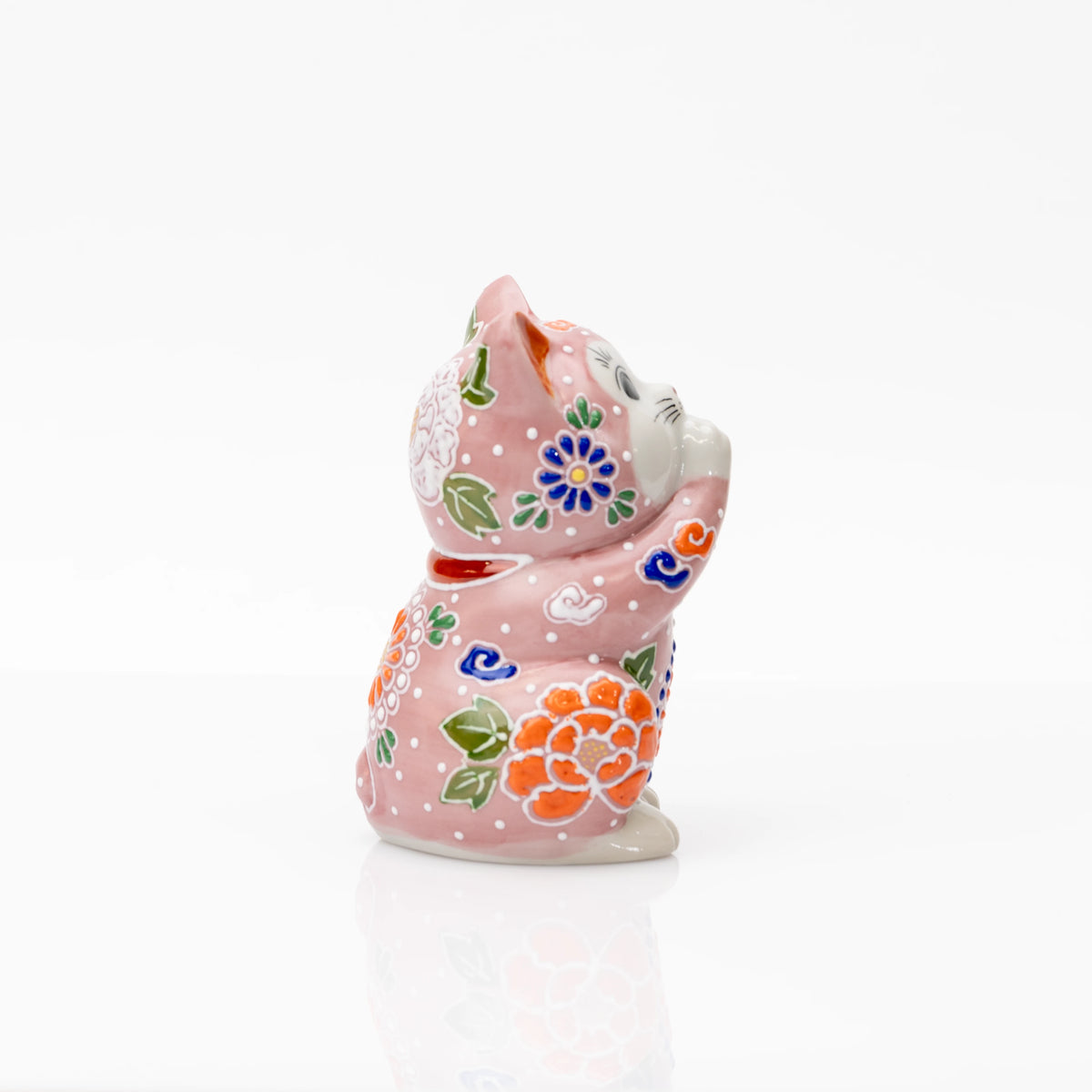 Side view of the pink floral praying cat and its joined paws.