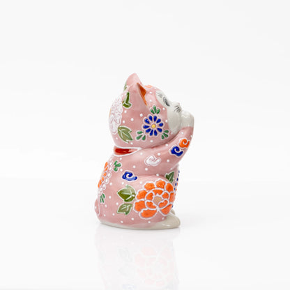 Side view of the pink floral praying cat and its joined paws.